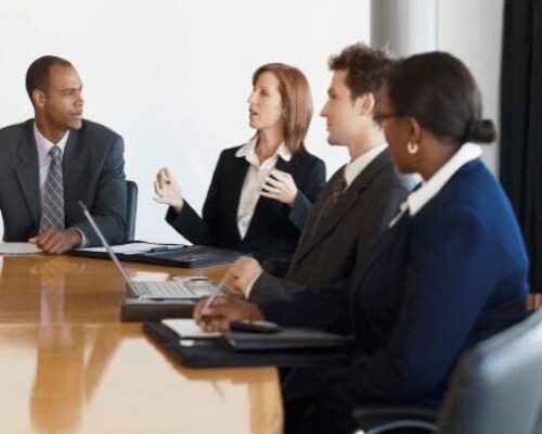 Business meeting with four people in discussion.
