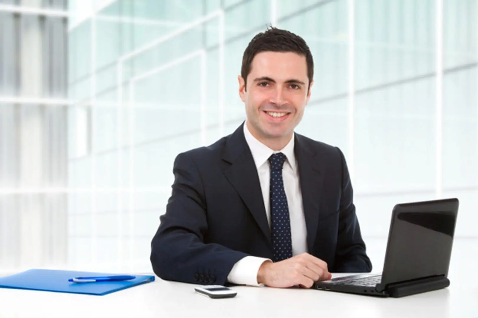 A man sitting at his desk with a laptop.