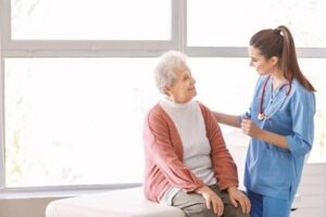 A nurse is talking to an older woman.