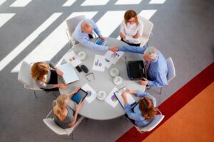 A group of people sitting around a table.