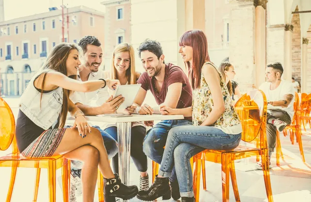 A group of people sitting around a table.