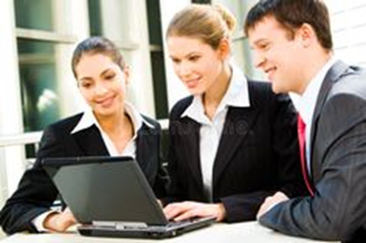 Three people are looking at a laptop screen.